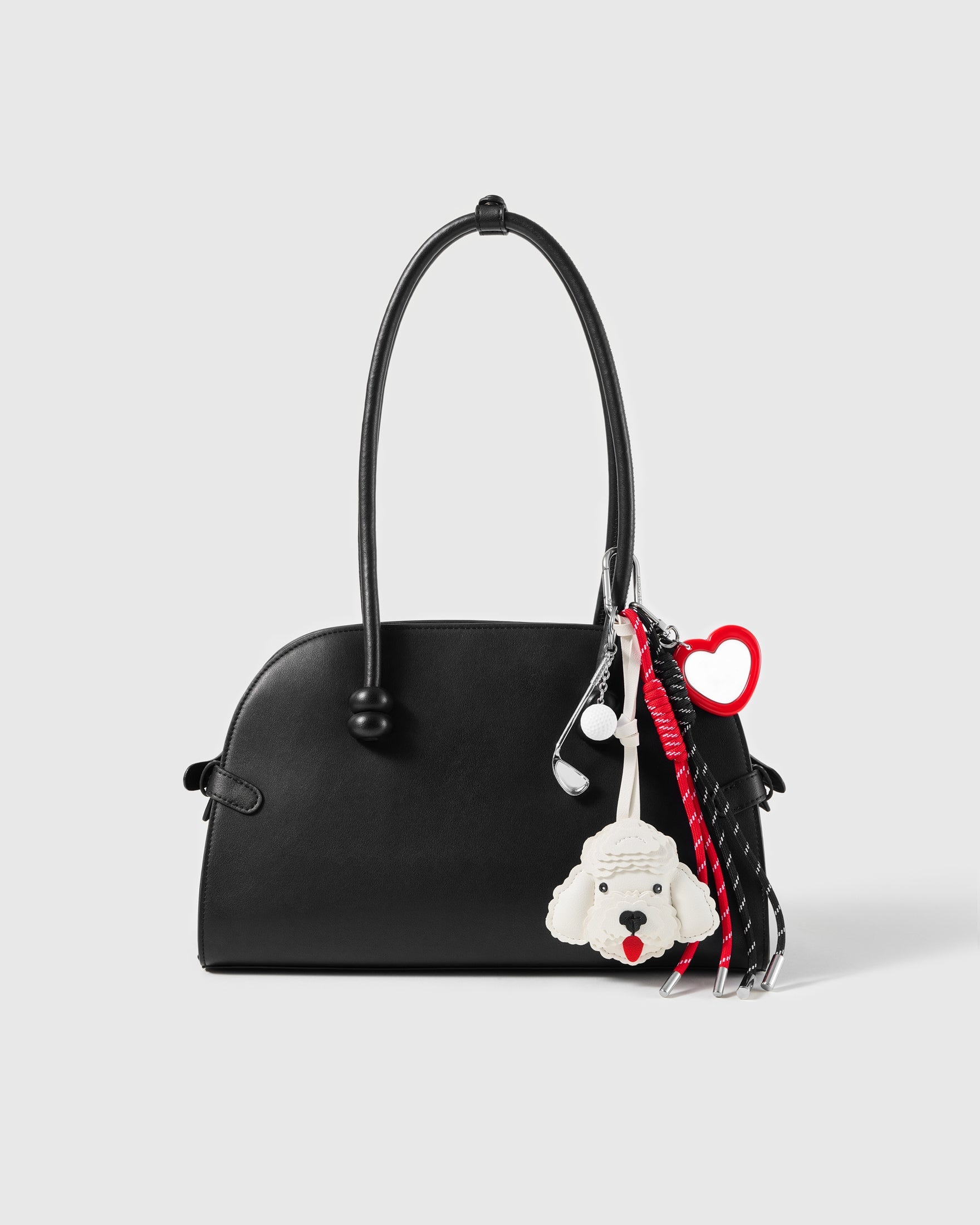White Poodle Golf Stack Charm attached to a structured handbag to show the complete design