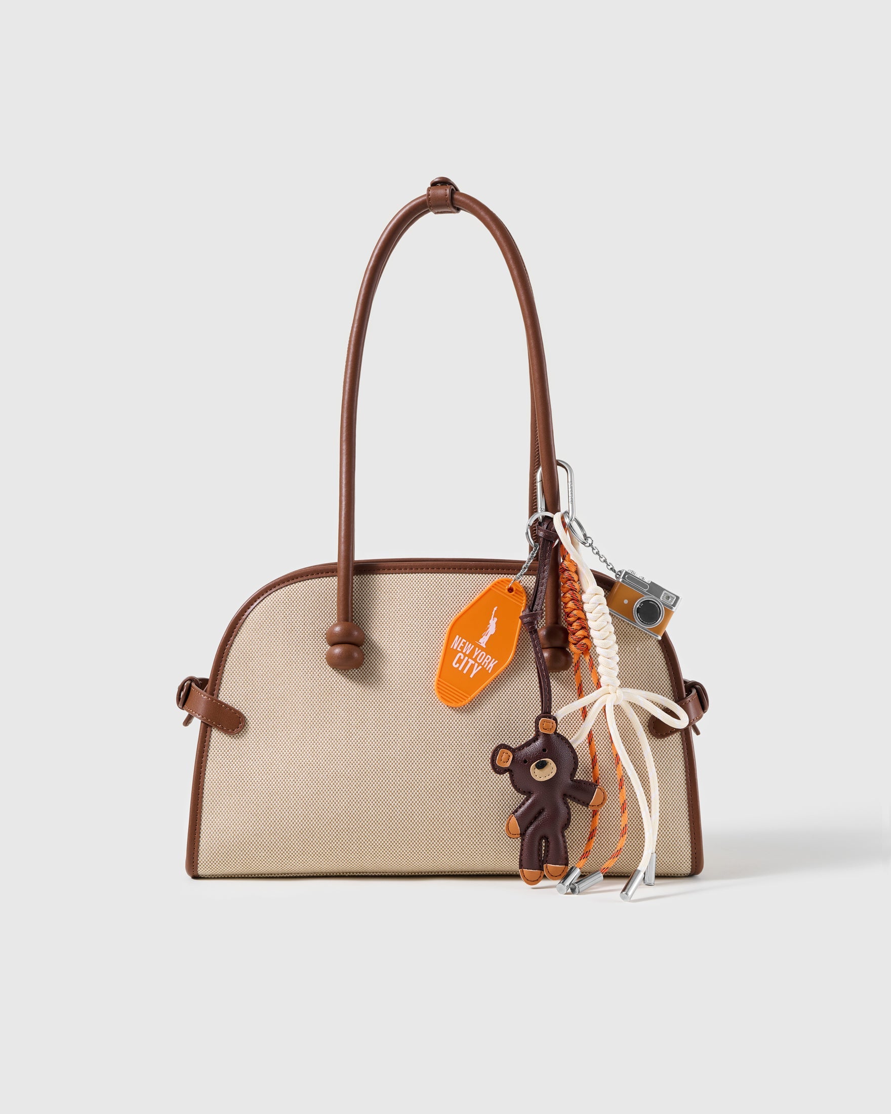 New York Teddy Camera Stack Charm attached to a structured handbag to show the complete design