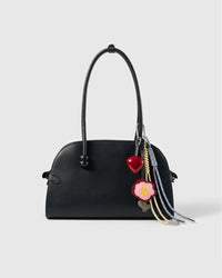 Lucky Money Flower Stack Charm attached to a structured handbag to show the complete design