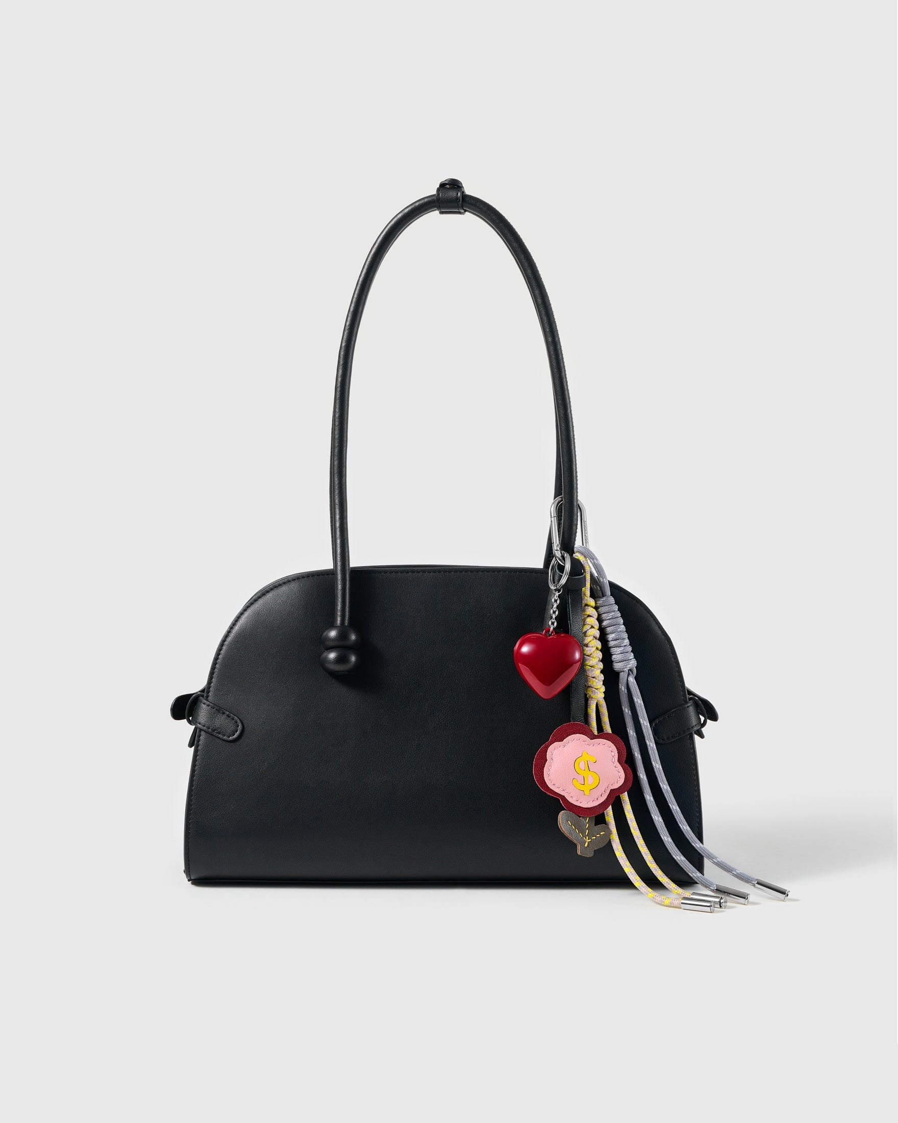 Lucky Money Flower Stack Charm attached to a structured handbag to show the complete design
