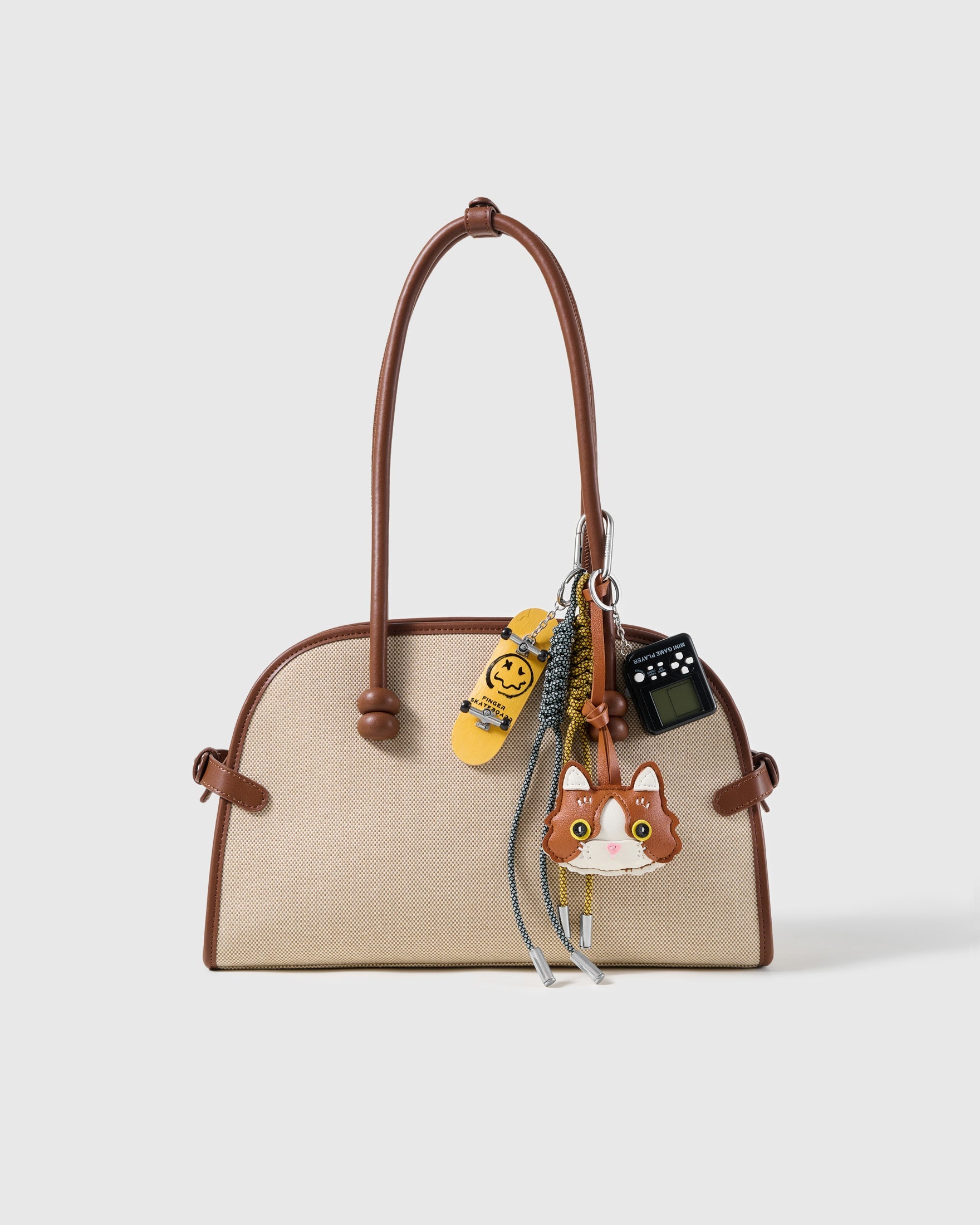 Tuxedo Cat Skate Stack Charm attached to a structured handbag to show the complete design