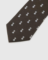 Espresso Tiger Cub Tie detail showing espresso ground with ivory tiger cubs and amber accents and the tactile silk surface.