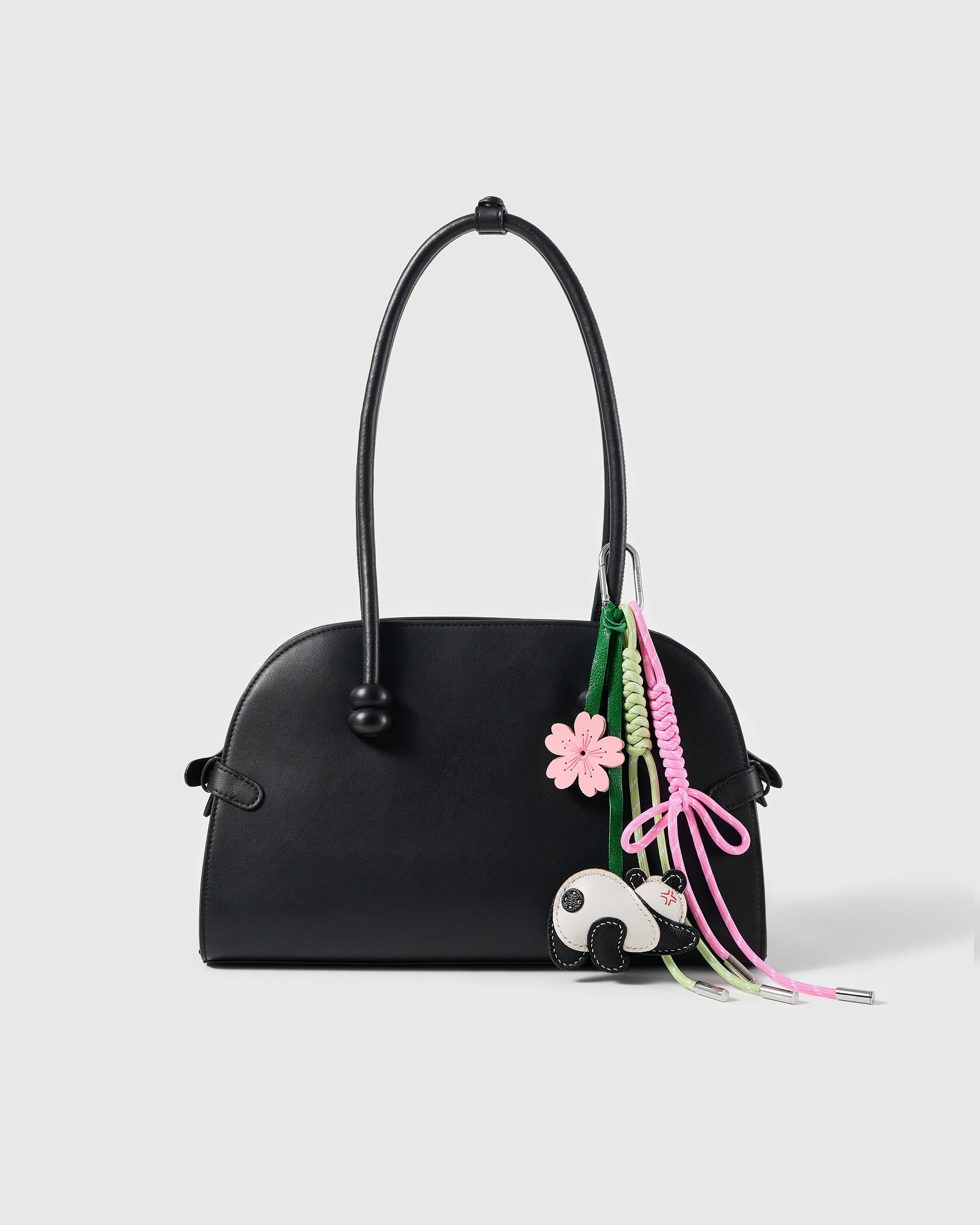 STICKYZOO Panda Blossom Bow Stack Charm clipped to a black handbag