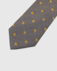 Pewter Herringbone Dot Tie detail showing mustard-gold dots over herringbone, raised thread and the tactile pewter silk surface.