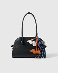 Dachshund Baseball Stack Charm attached to a structured handbag to show the complete design