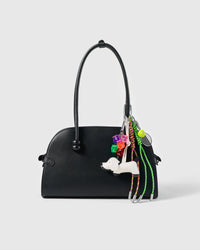 Tennis Pup Stack Charm attached to a structured handbag to show the complete design