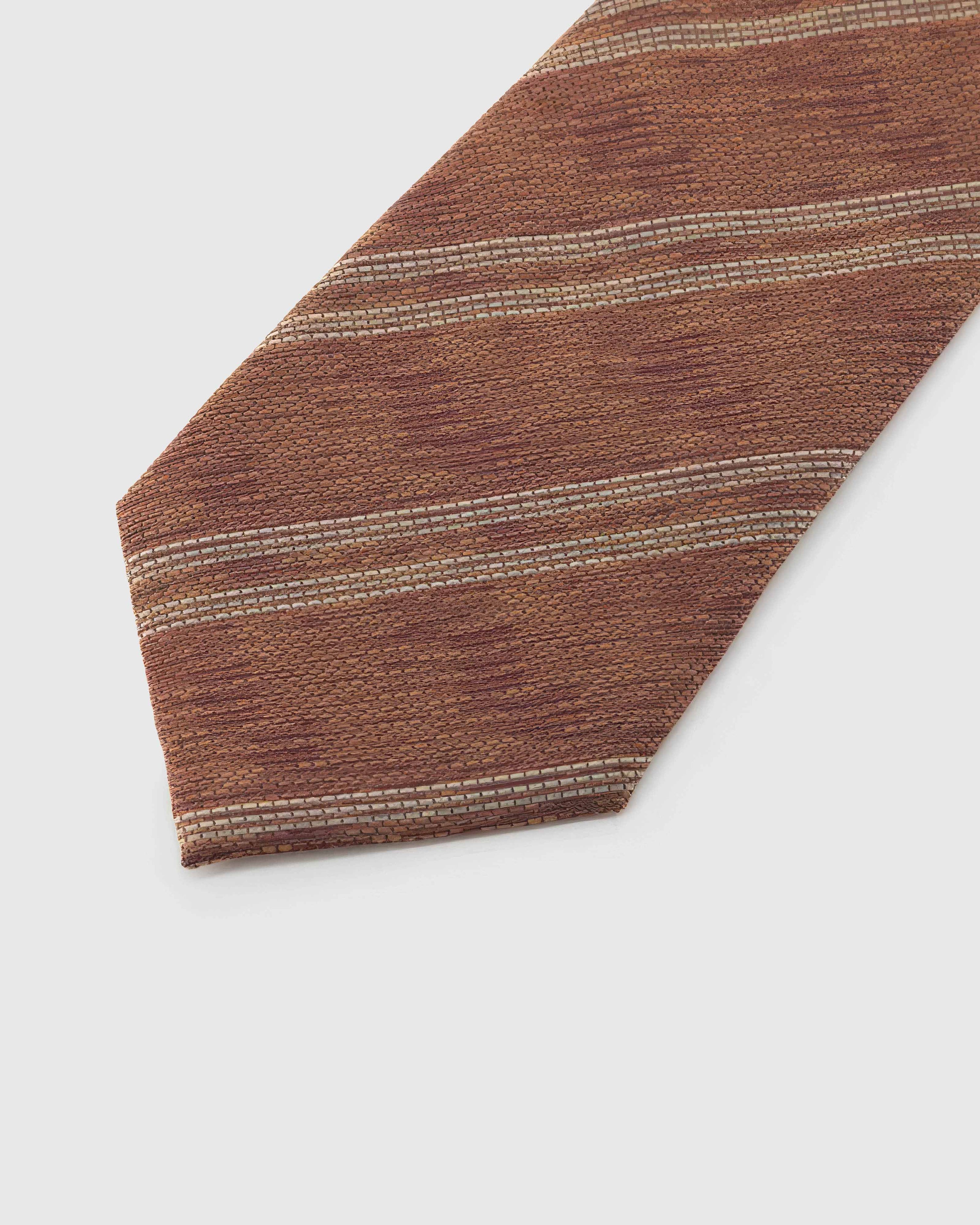 Rosewood Textured Stripe Tie detail showing broken cream diagonal stripes, raised thread and the tactile rosewood silk surface.
