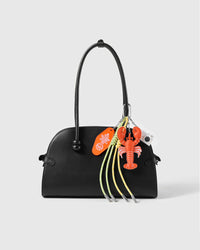 Lobster Camera Stack Charm attached to a structured handbag to show the complete design