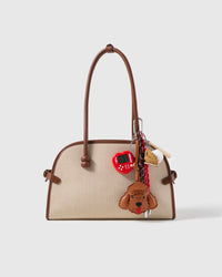 Cocoa Poodle Game Stack Charm attached to a structured handbag to show the complete design