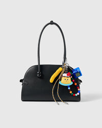 Arcade Cake Bead Stack Charm attached to a structured handbag to show the complete design