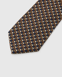 Espresso Chevron Tie detail showing espresso, cobalt, ivory and taupe micro chevrons and the tactile silk surface.