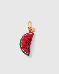STICKYZOO Lola Watermelon Pop charm with a curved red bead-covered slice, black seed pattern, white rind line, green edge, gold-tone swivel clasp, and engraved tag on a pale background