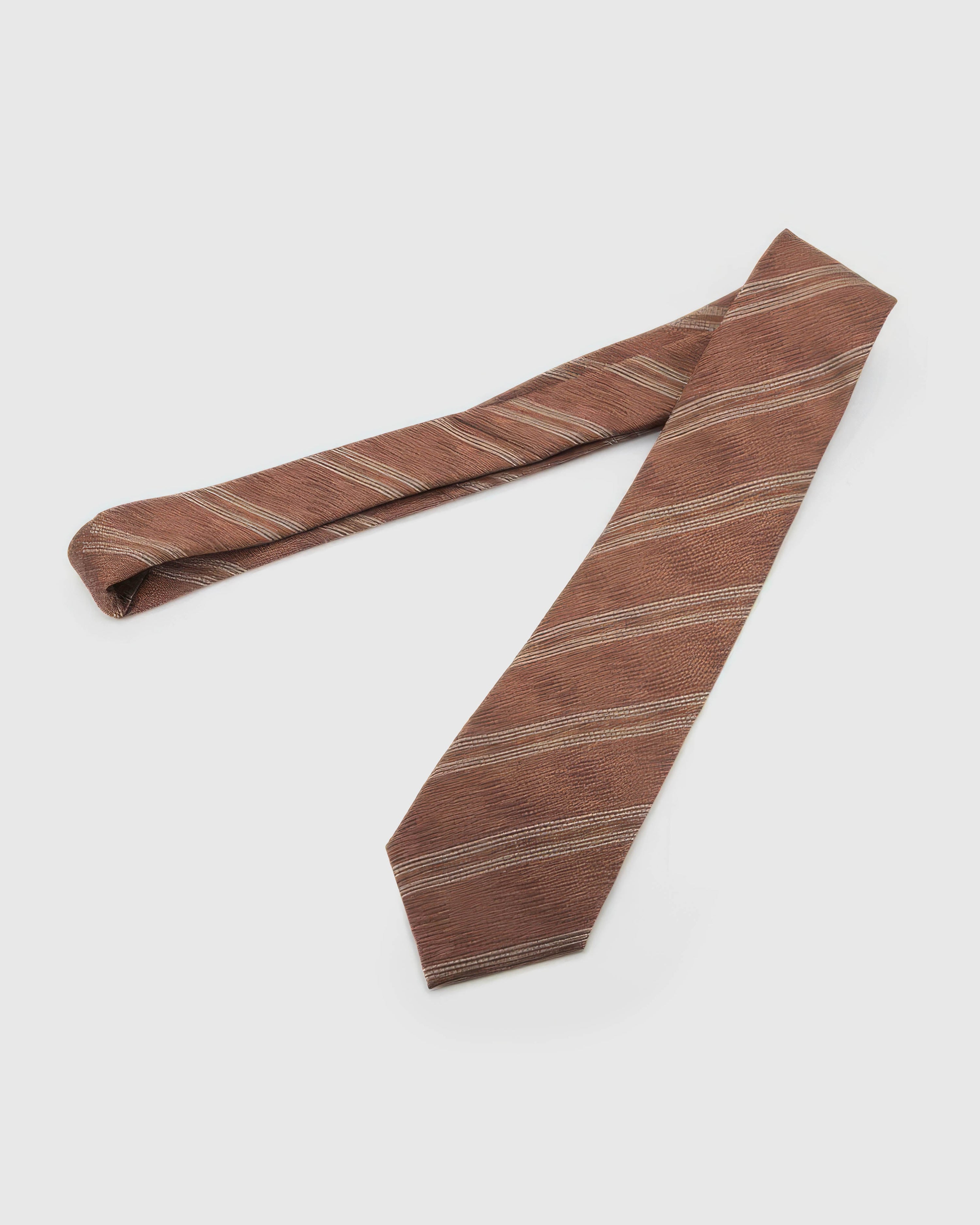 Rosewood Textured Stripe Tie laid full length on white, showing a textured rosewood ground crossed by broken cream diagonal bands from blade to tail.