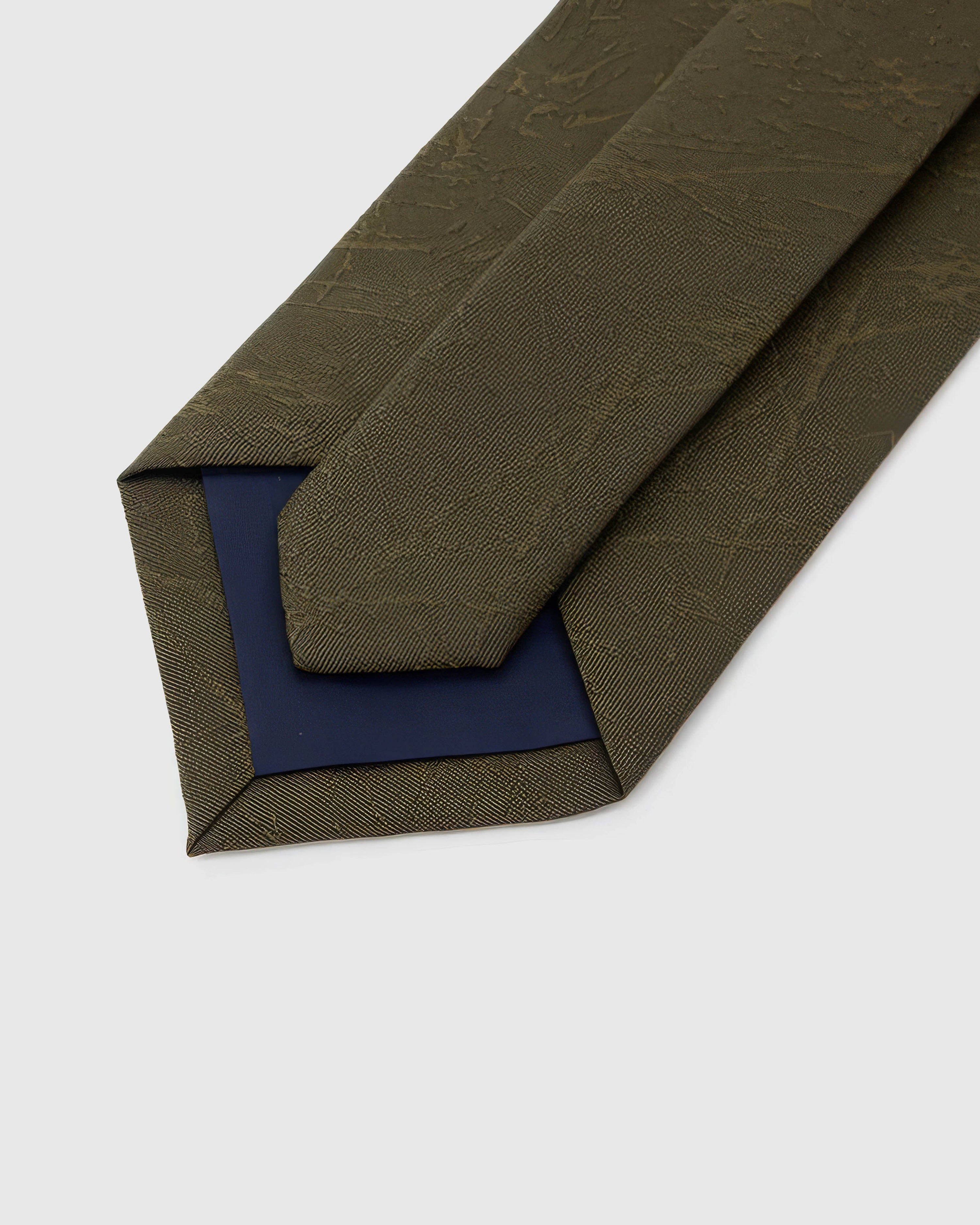 Back of STICKYZOO Moss Relief Texture Tie showing structured interlining, hand-finished folds and slip stitching, 145 × 8 cm