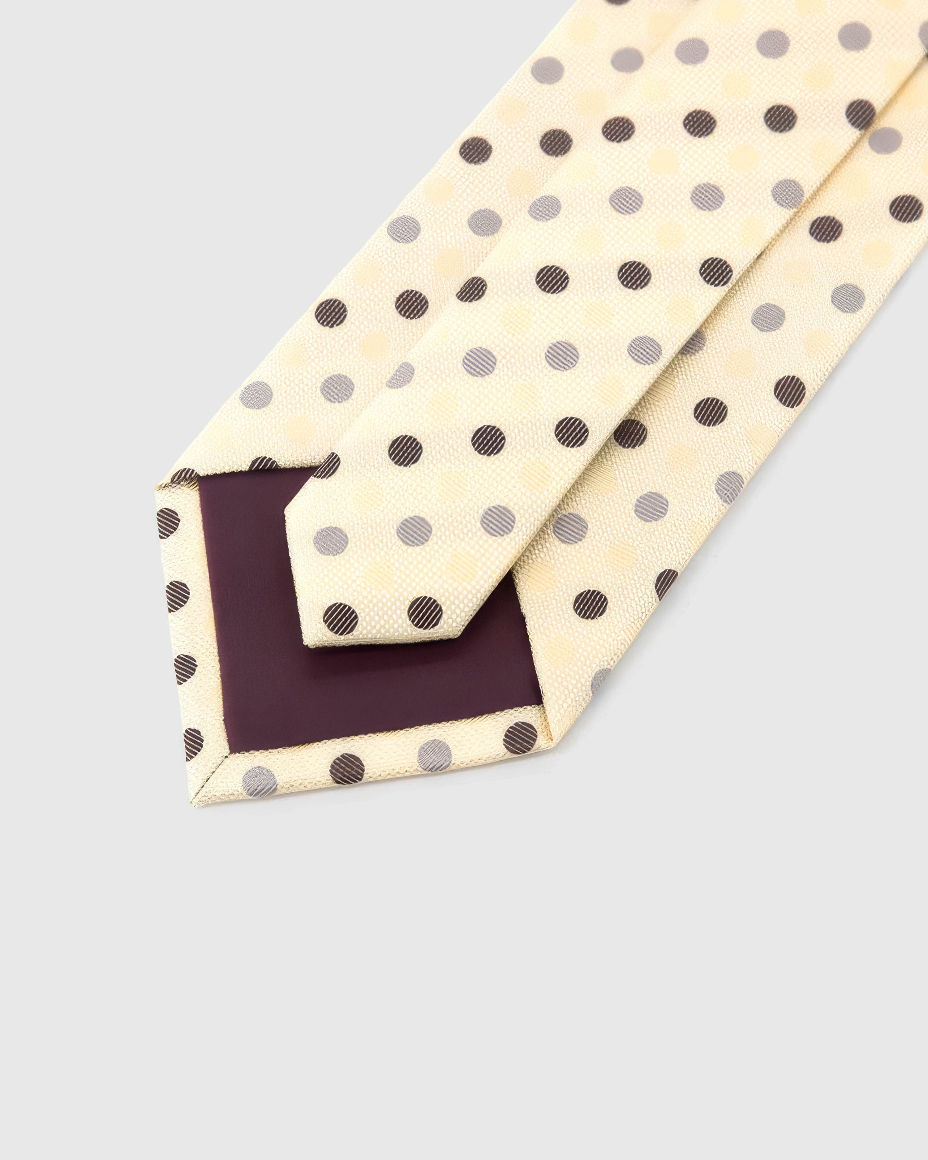 Back of STICKYZOO Ivory Tricolor Dot Tie showing burgundy structured interlining, hand-finished folds and keeper, 145 × 8 cm