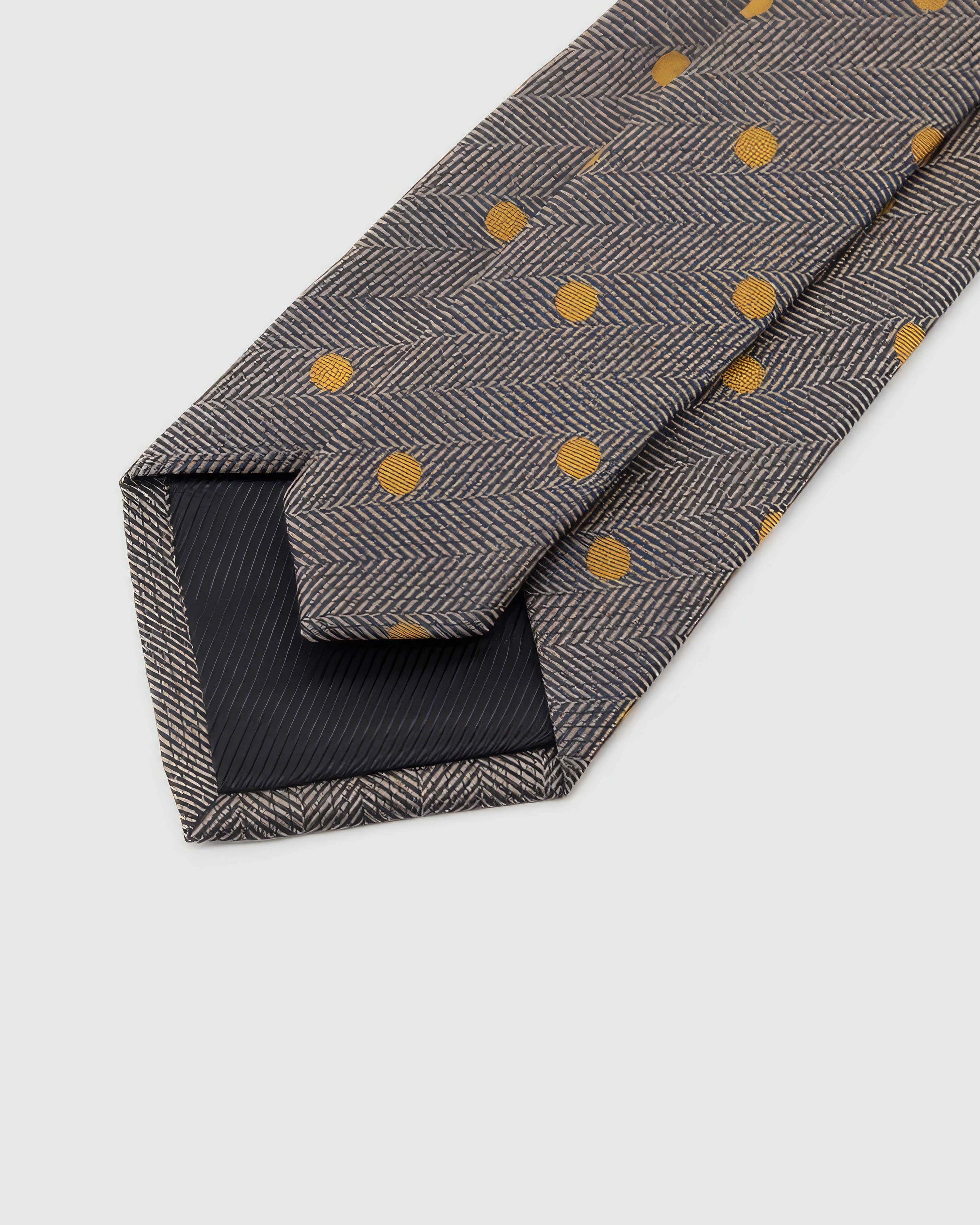 STICKYZOO Pewter Herringbone Dot Tie reverse showing structured interlining and hand-finished slip stitching, 145 × 8 cm.