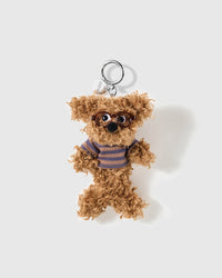 Cocoa curly poodle charm wearing tortoiseshell glasses and a brown striped top with a round silver-colour clip