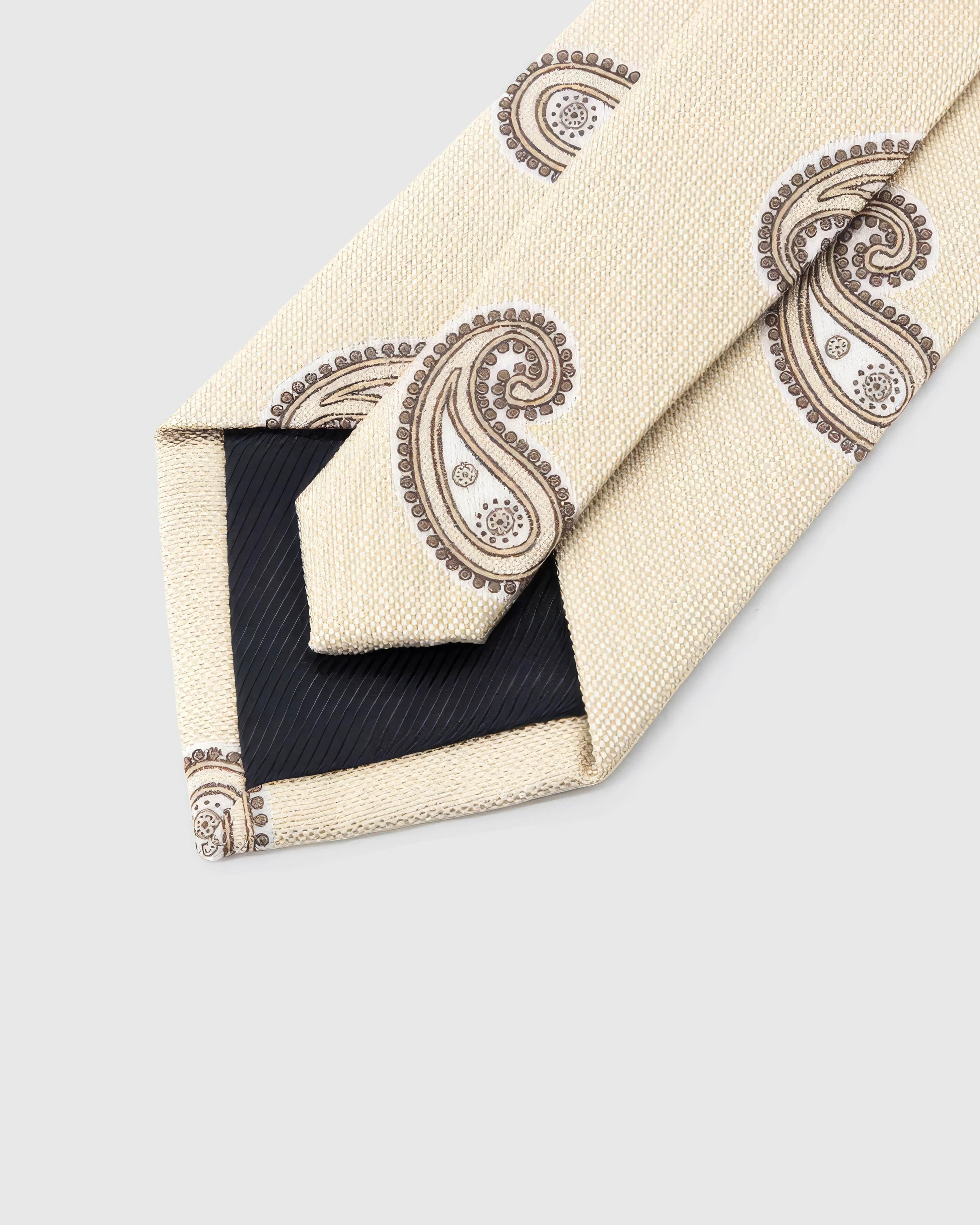 STICKYZOO Ivory Taupe Paisley Tie reverse showing structured interlining and hand-finished slip stitching, 145 × 8 cm.