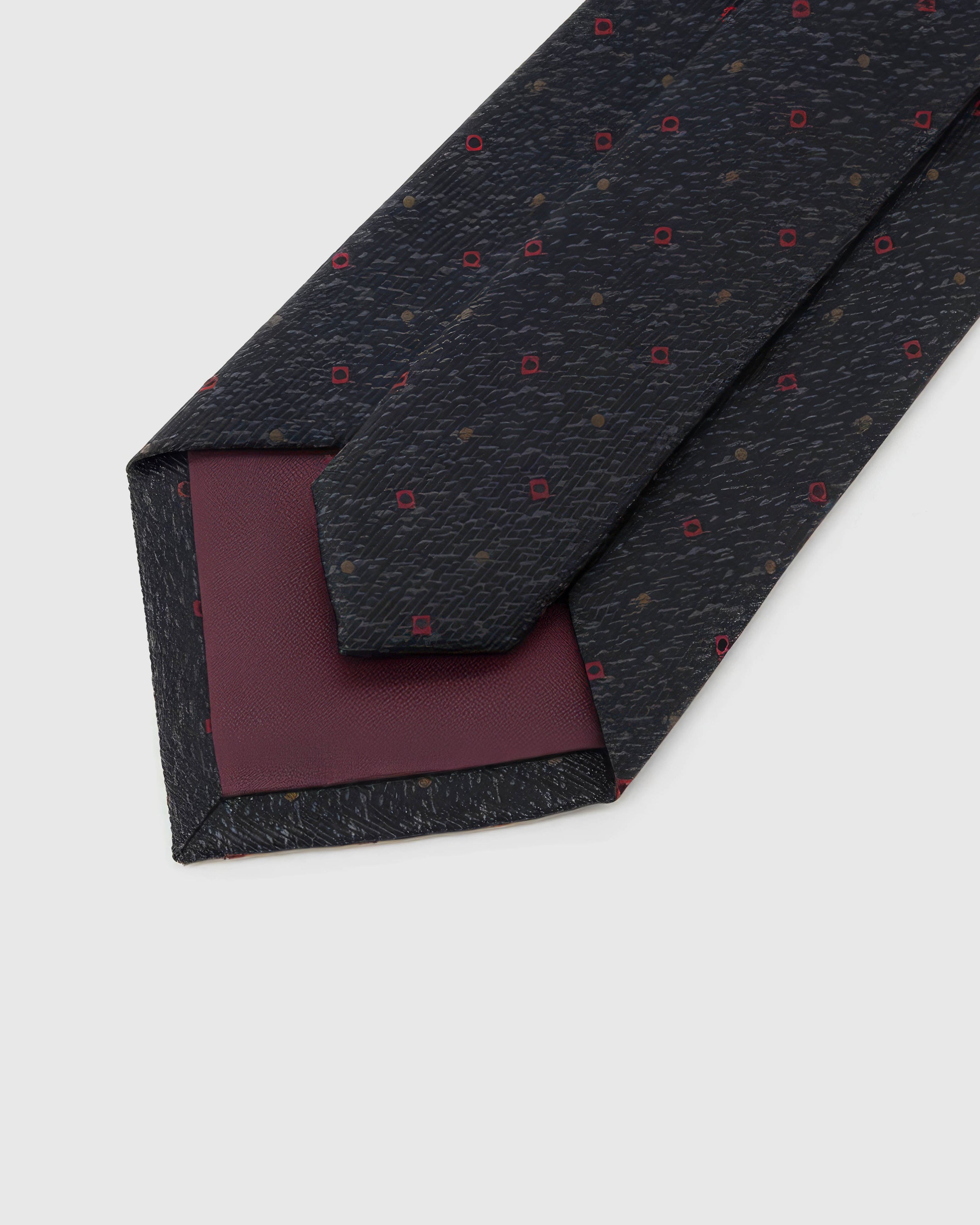 Back of STICKYZOO Onyx Crimson Tile Tie showing burgundy structured interlining, hand-finished folds and keeper, 145 × 8 cm