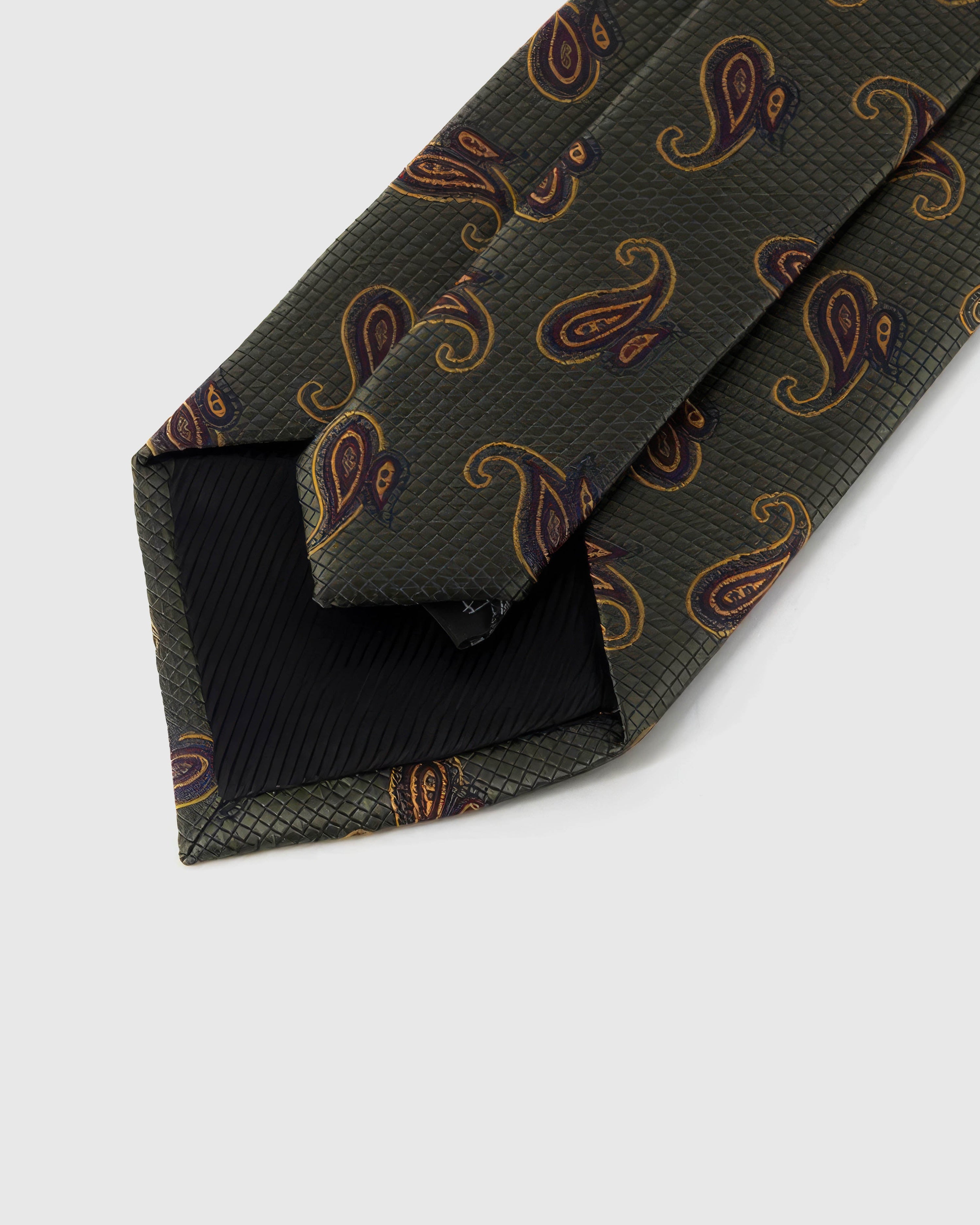 Back of STICKYZOO Hunter Amber Paisley Tie showing structured interlining, hand-finished folds and slip stitching, 145 × 8 cm