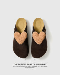 Pair of heart-detail suede clogs showing the open heel, closed toe, and easy slip-on shape