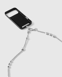 Dual silver-tone clasps and engraved STICKYZOO disc connecting the heart and bead strap to a black phone case.