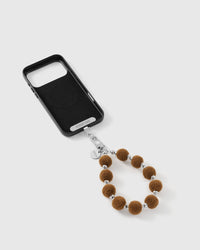 Close-up of the silver-tone hook, engraved STICKYZOO disc and the plush hazelnut pom beads and silver-tone beads — soft and tactile