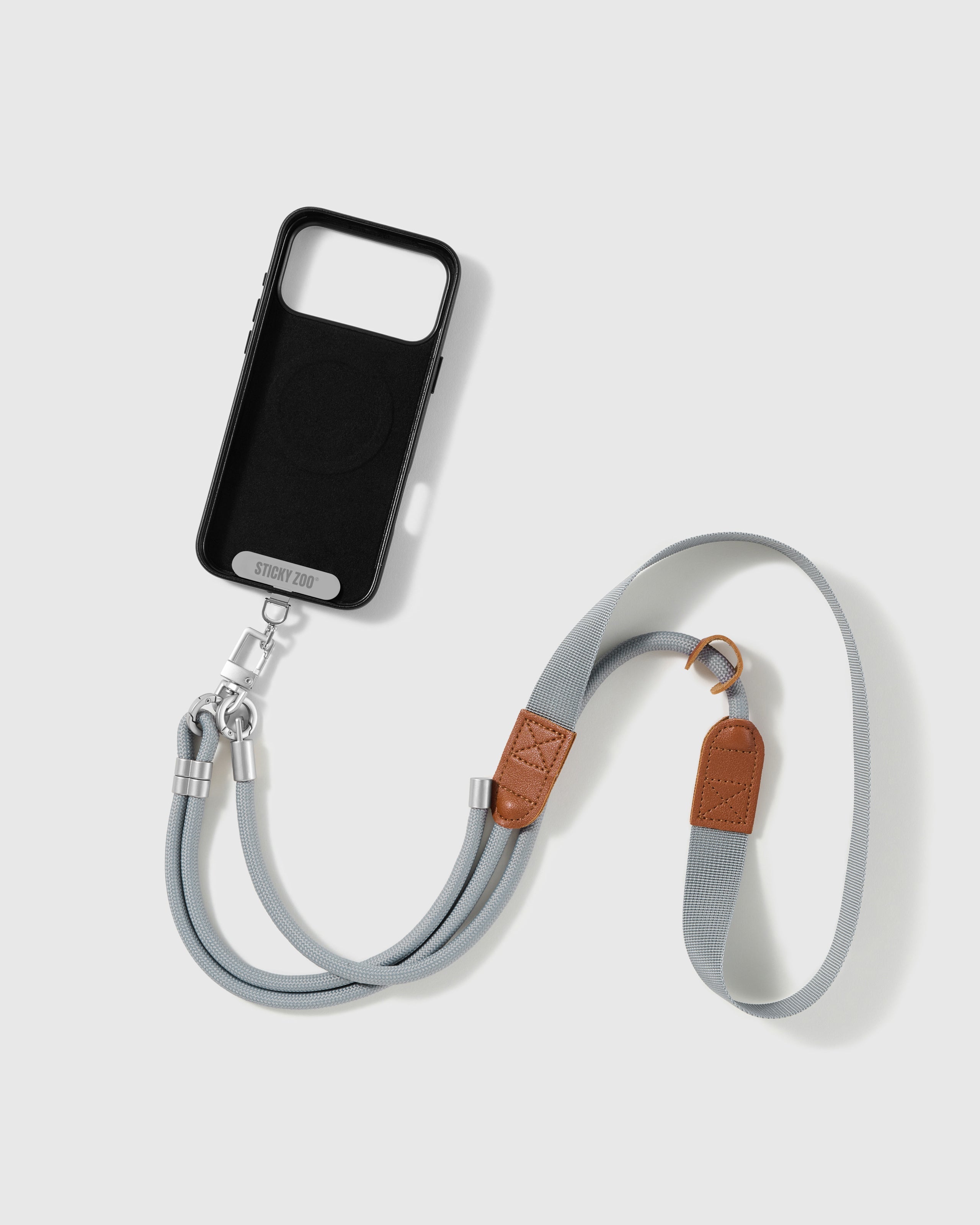 STICKYZOO mist-grey cross-body phone strap attached to a phone case through the included Phone Strap Card
