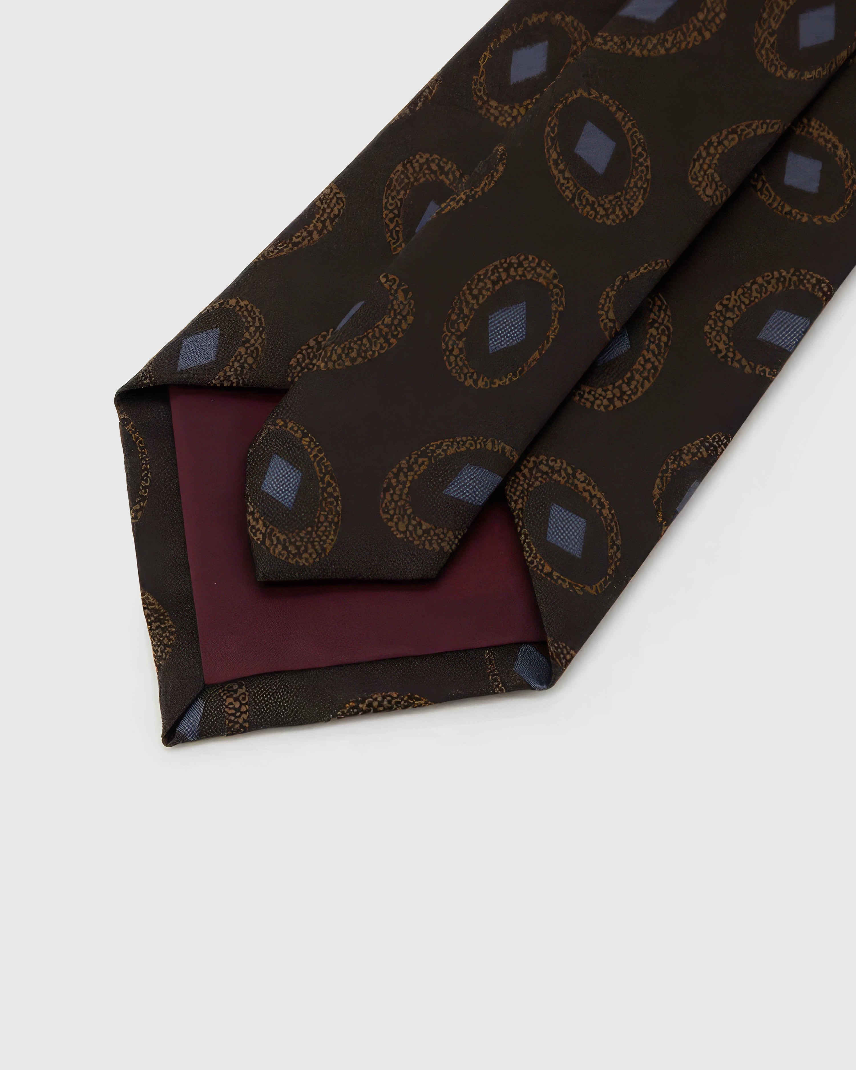 STICKYZOO Espresso Medallion Tie reverse showing structured interlining and hand-finished construction, 145 × 8 cm.