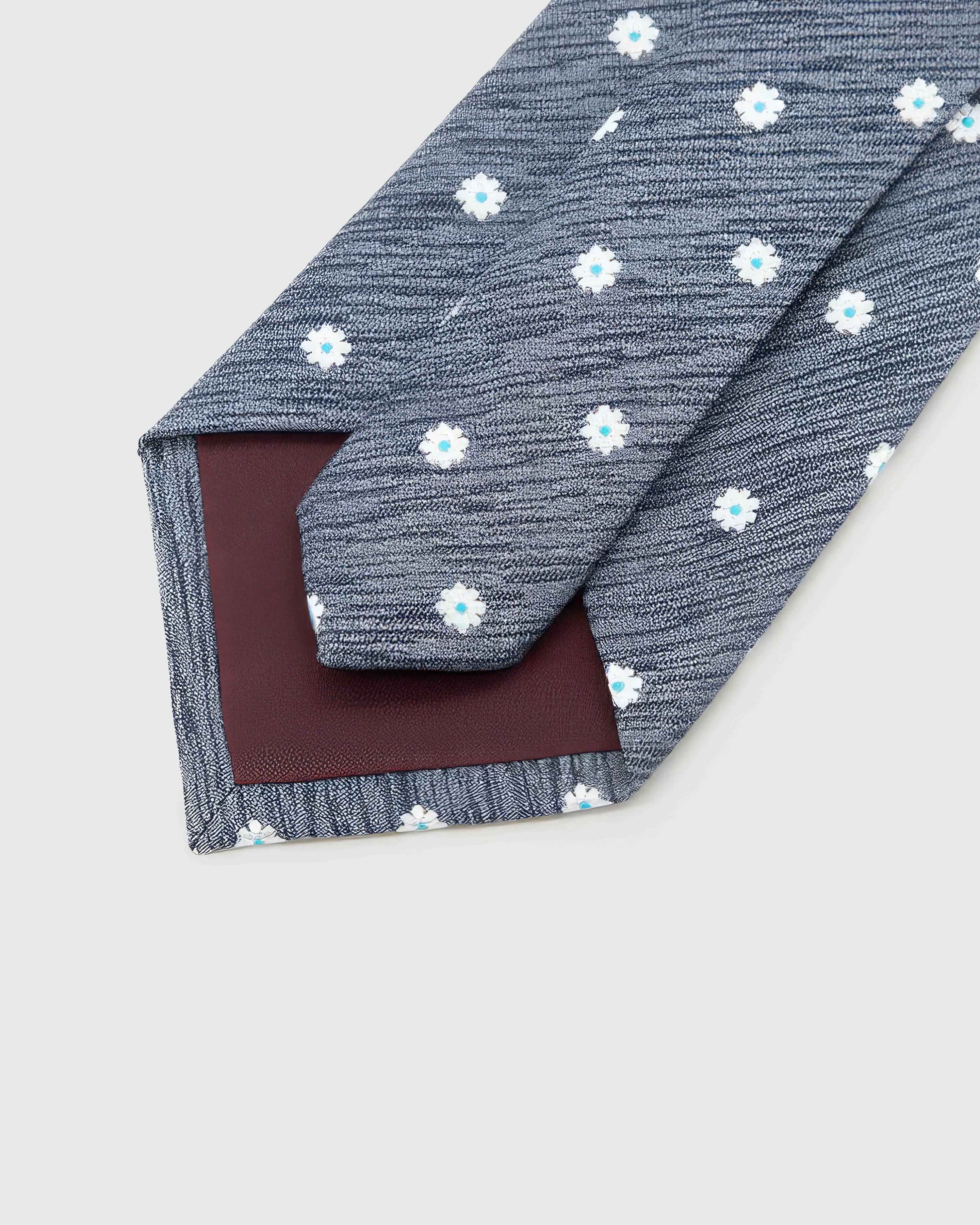 Back of STICKYZOO Slate Daisy Tie showing burgundy structured interlining, hand-finished folds and keeper, 145 × 8 cm