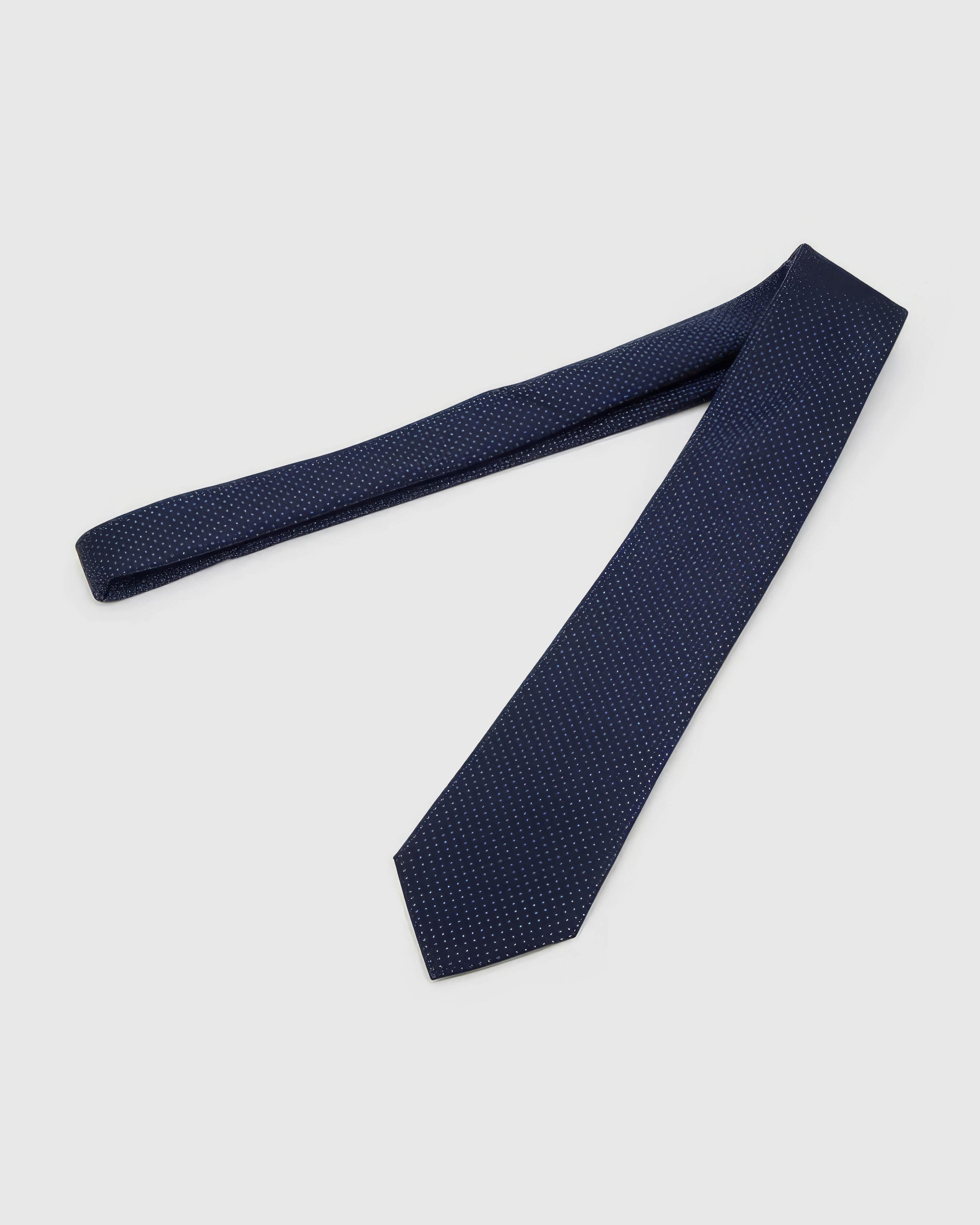 Midnight Micro-Square Tie laid full length to show midnight and indigo dense micro-square grid from blade to tail.