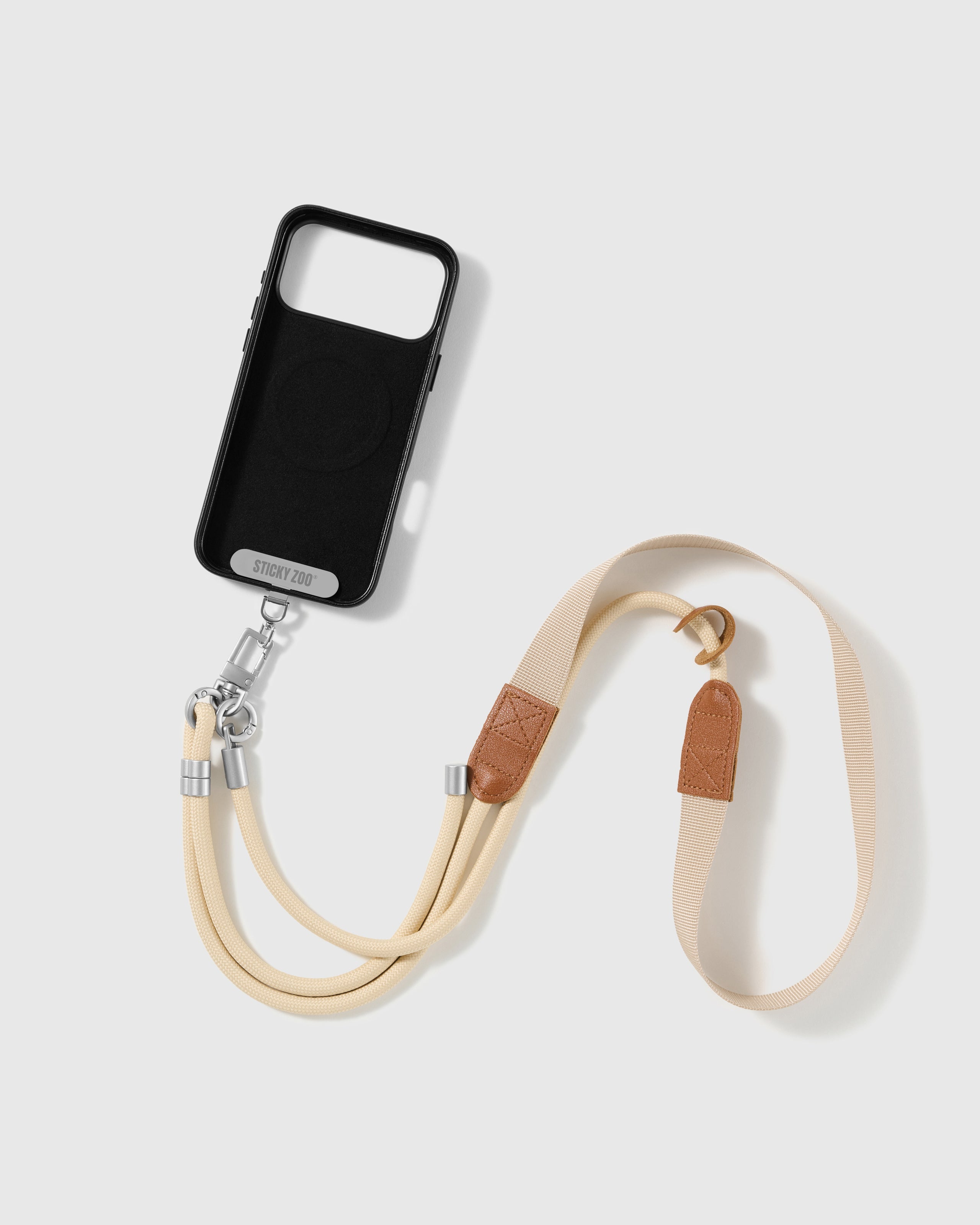STICKYZOO ivory cross-body phone strap attached to a phone case through the included Phone Strap Card