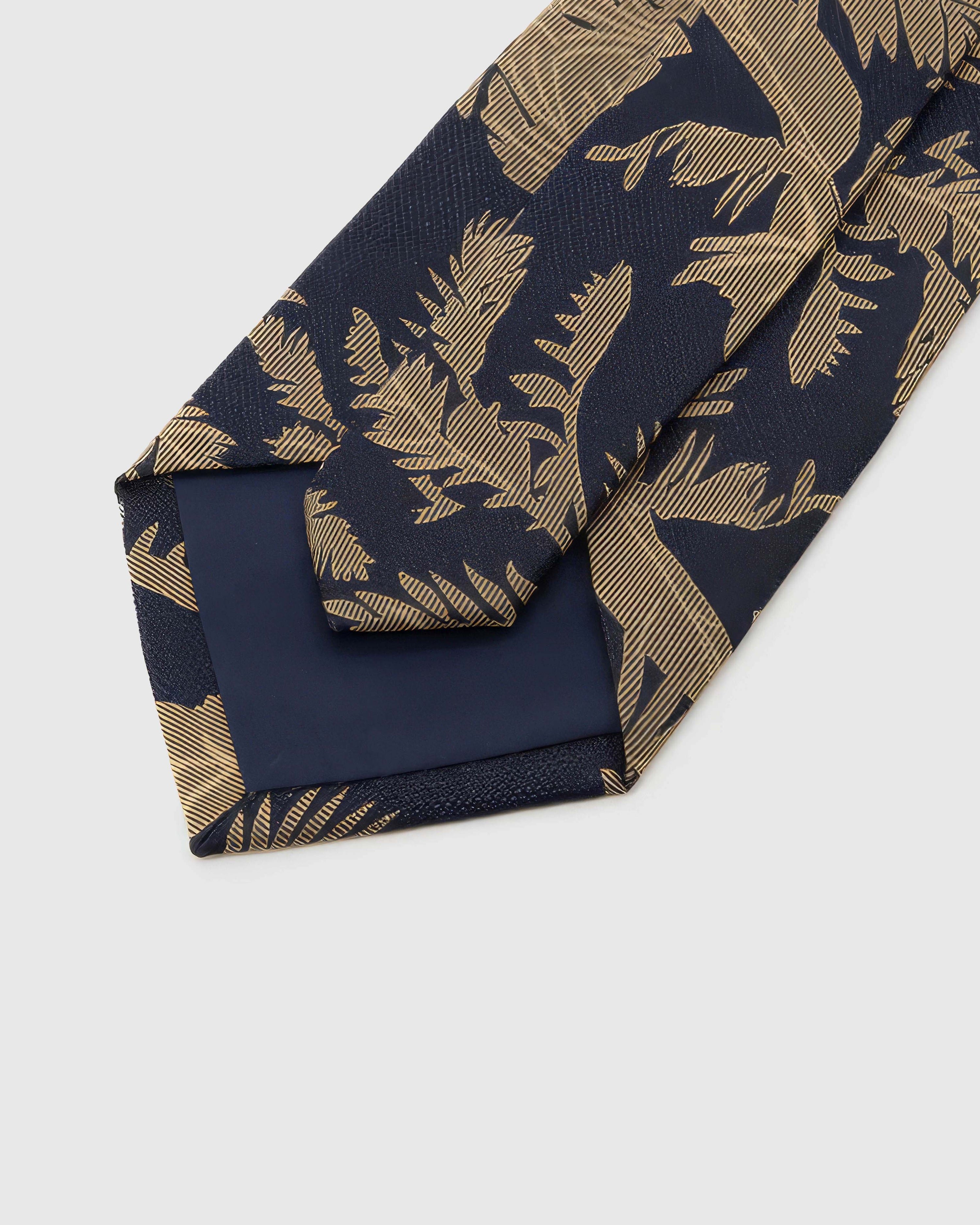 Back of STICKYZOO Navy Gilt Foliage Tie showing structured interlining, hand-finished folds and slip stitching, 145 × 8 cm