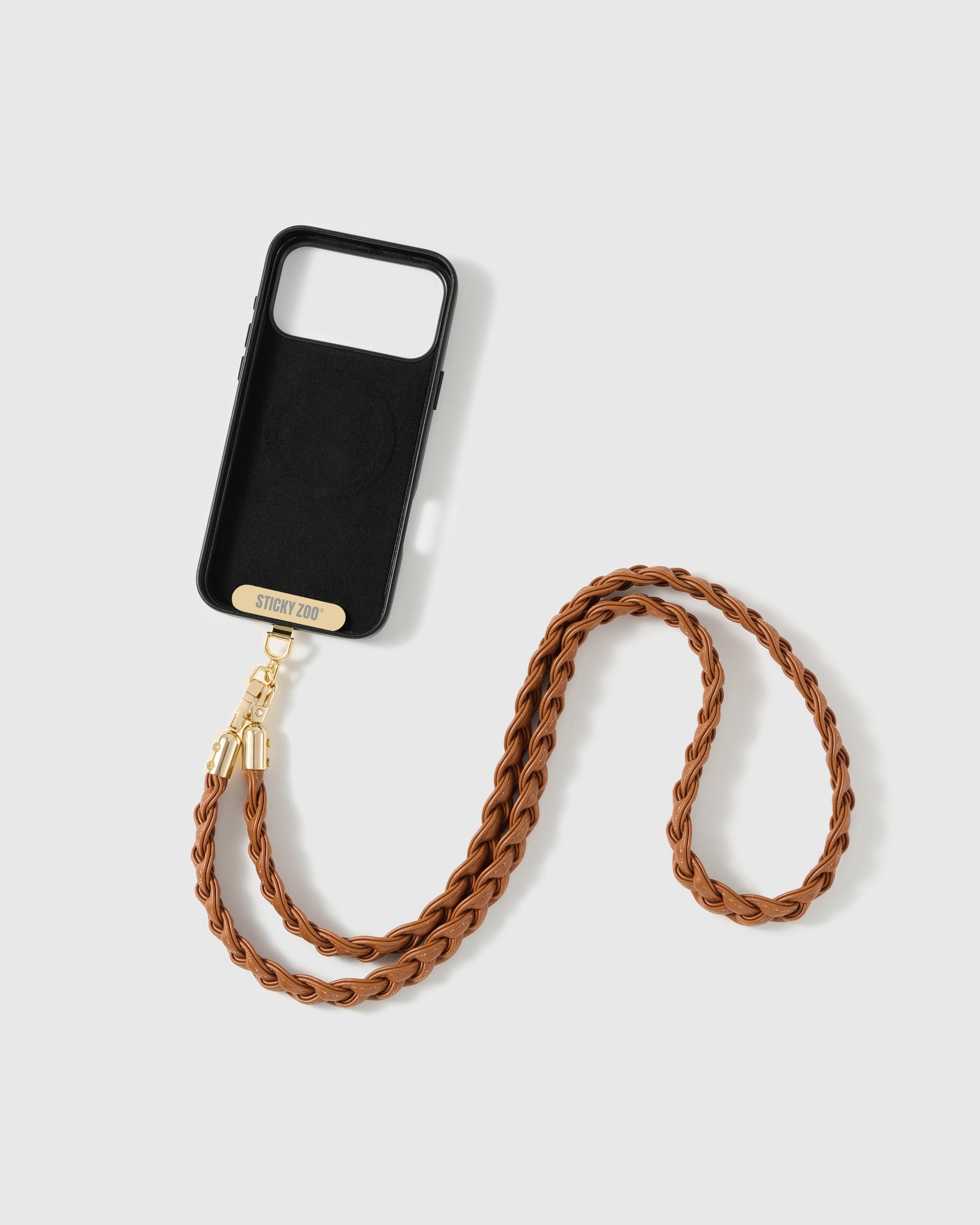 STICKYZOO cognac woven phone strap attached to a phone case through the included Phone Strap Card