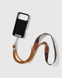 Amber cord and espresso webbing phone strap attached to a black phone case for hands-free cross-body carry
