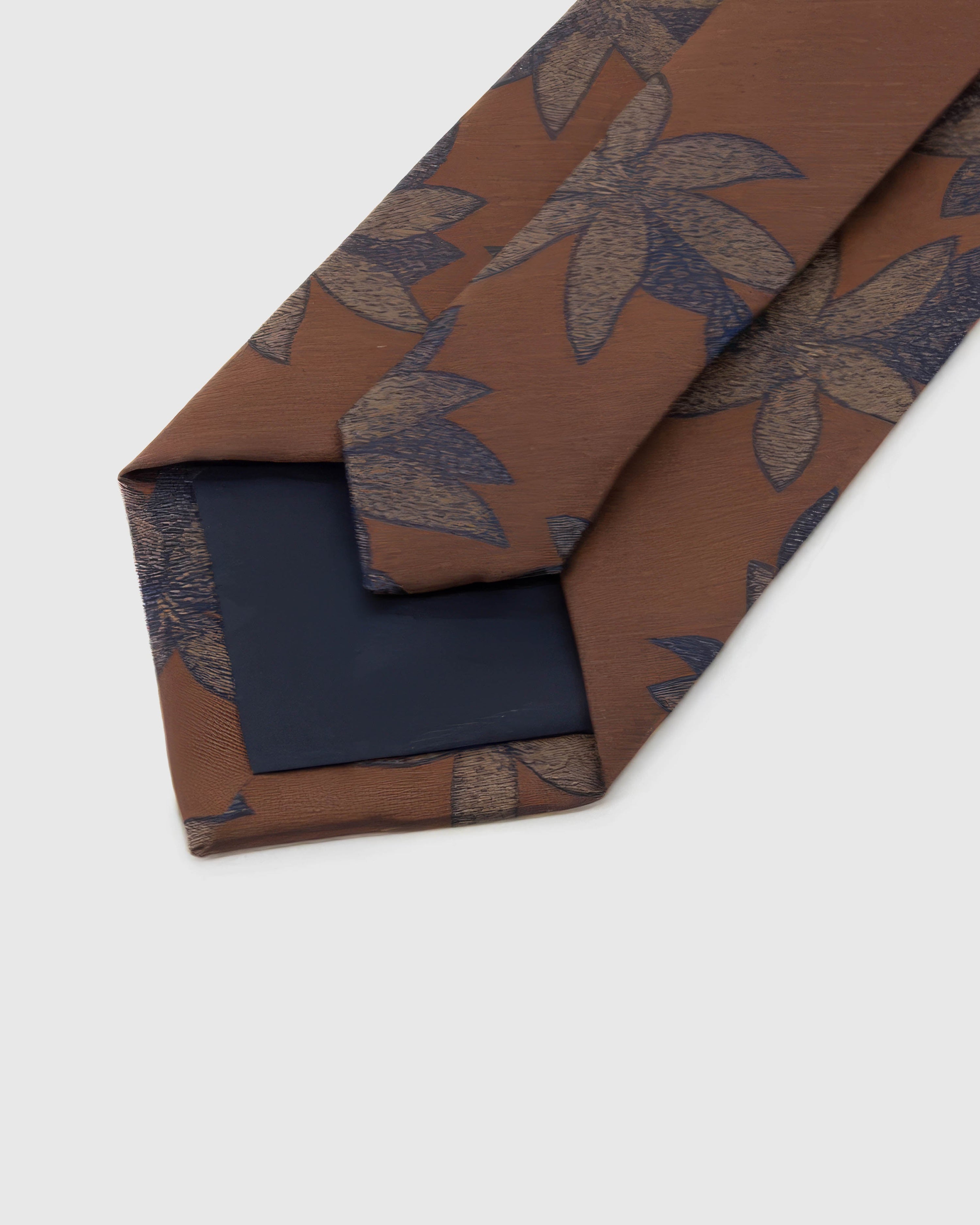 Back of STICKYZOO Caramel Botanical Bloom Tie showing structured interlining, hand-finished folds and slip stitching, 145 × 8 cm