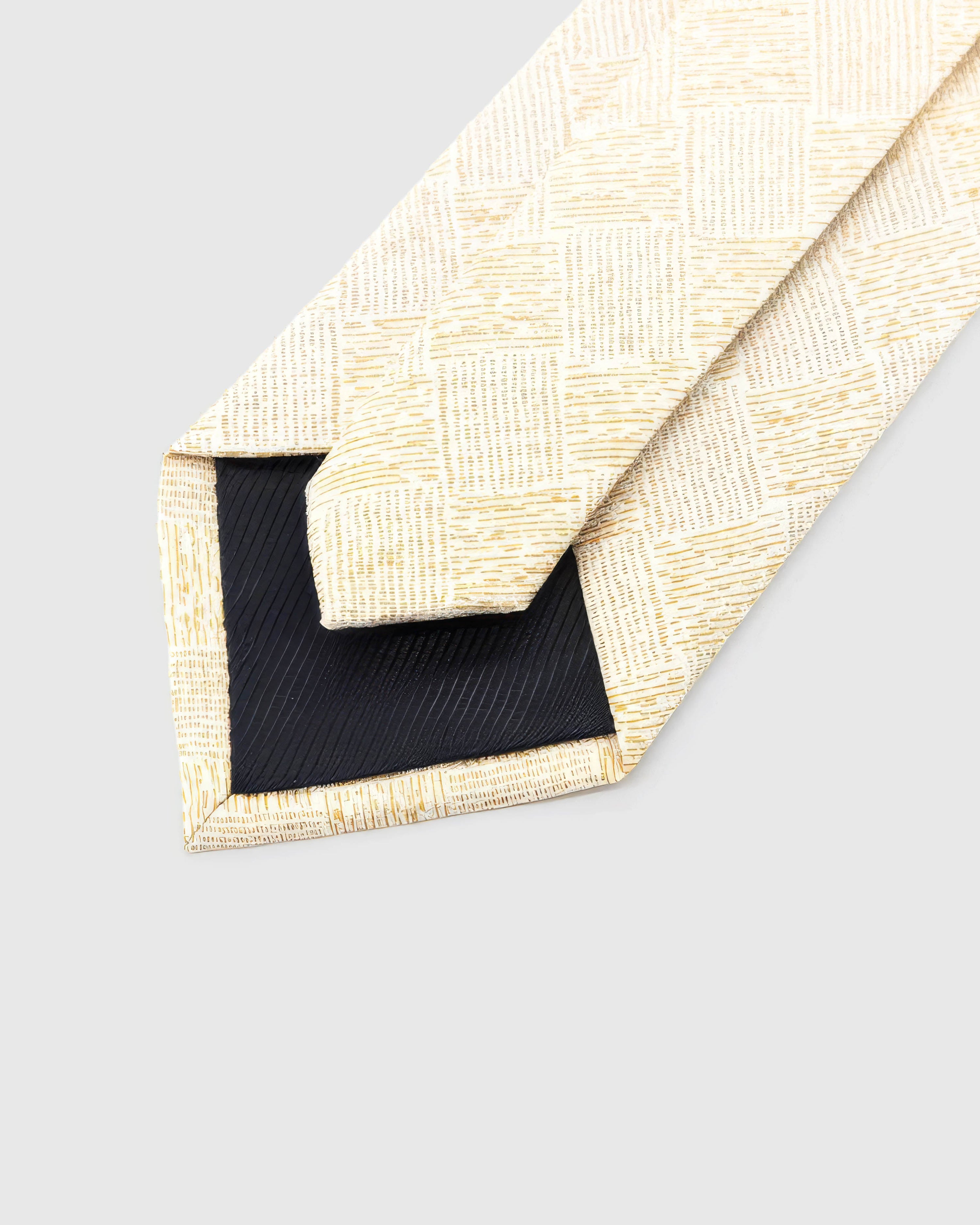 STICKYZOO Ivory Gilded Grid Tie reverse showing structured interlining and hand-finished slip stitching, 145 × 8 cm.