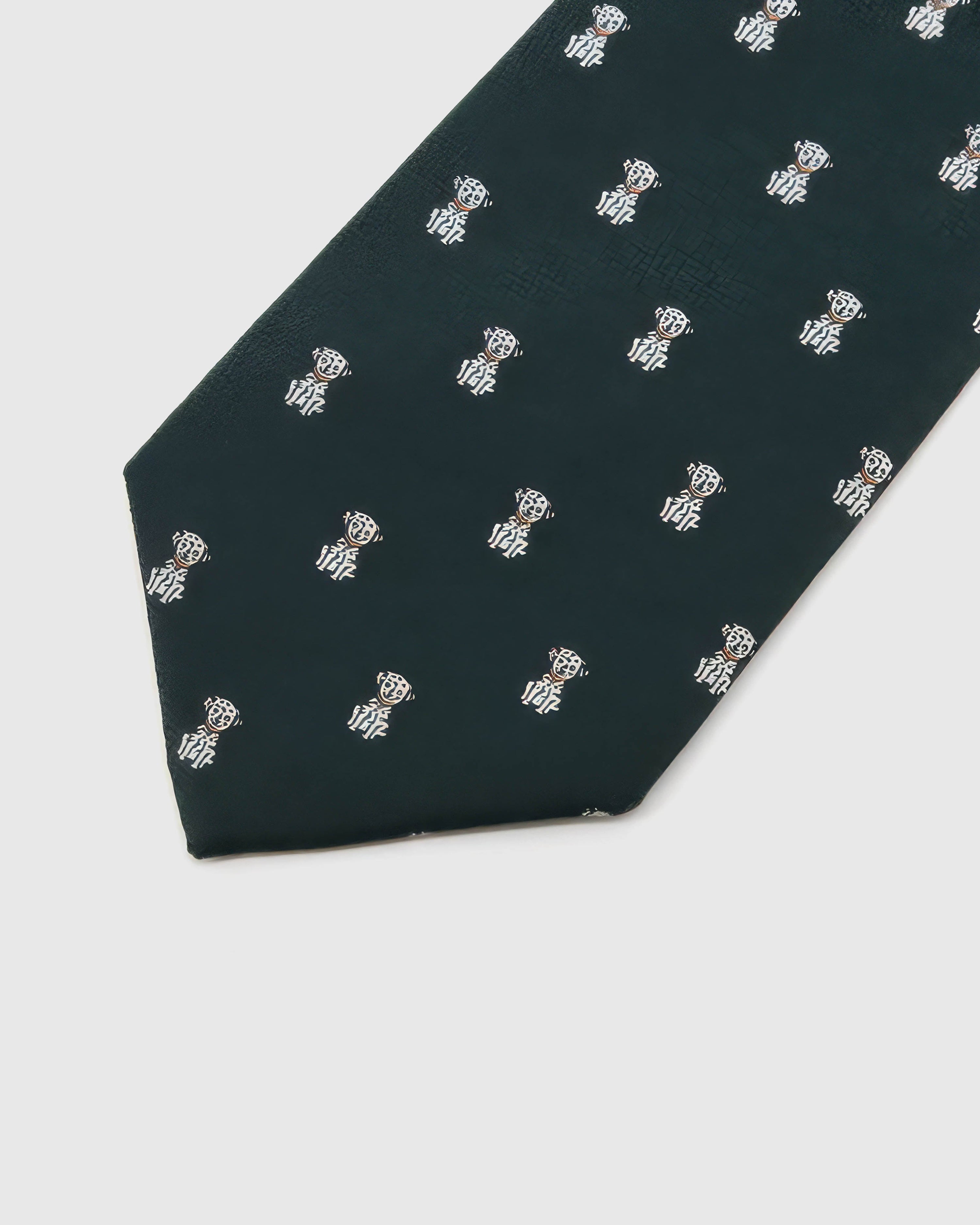 Forest Tiger Cub Tie detail showing forest ground with ivory tiger cubs and amber accents and the tactile silk surface.