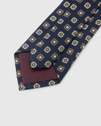 Back of STICKYZOO Navy Medallion Tile Tie showing burgundy structured interlining, hand-finished folds and keeper, 145 × 8 cm