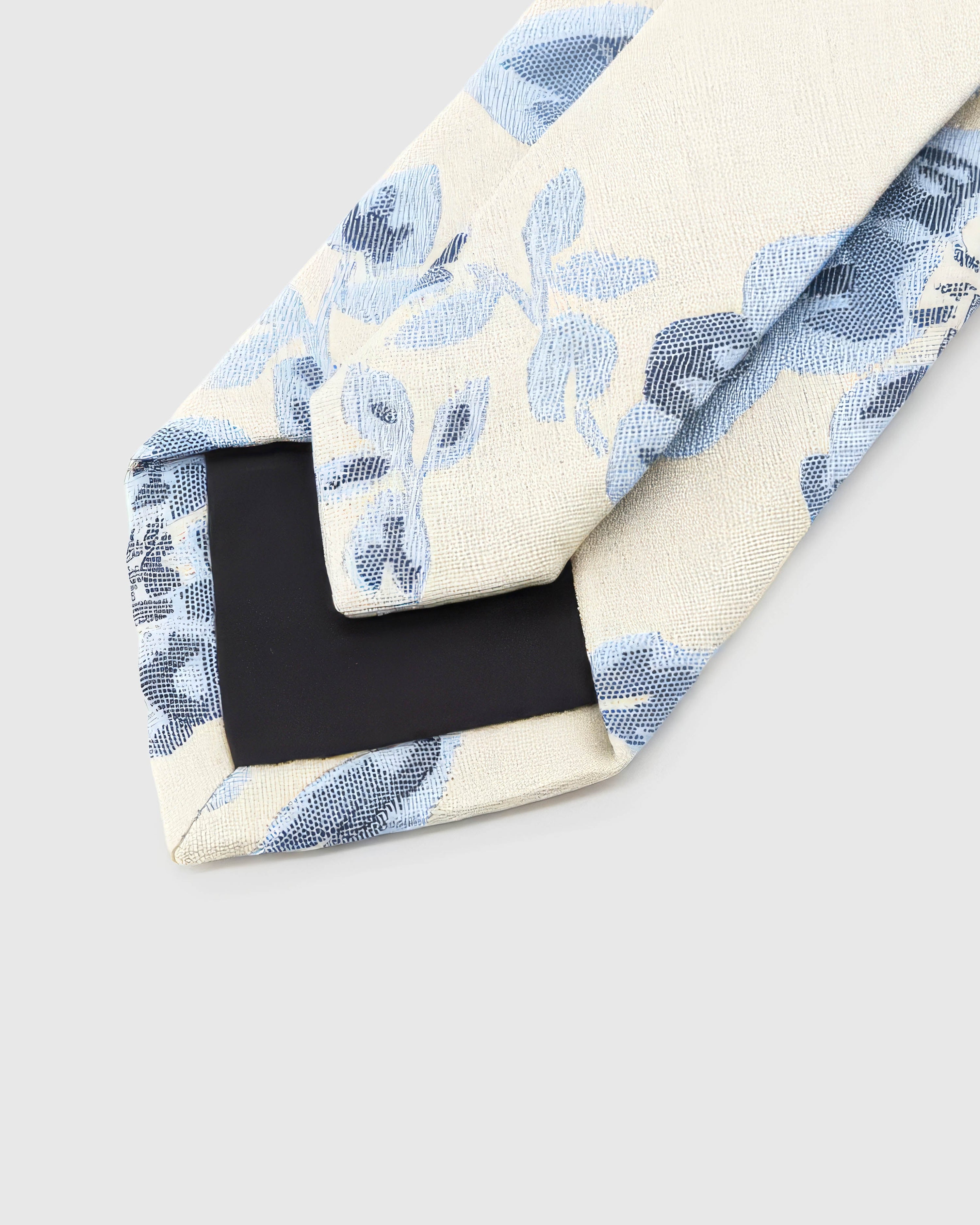 STICKYZOO Ivory Porcelain Bloom Tie reverse showing structured interlining and hand-finished slip stitching, 145 × 8 cm.