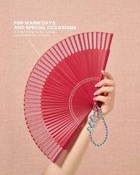 Folded camellia hand fan shown beside its fabric storage sleeve