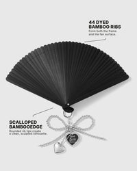 Open black hand fan showing 44 dyed bamboo ribs and scalloped edge