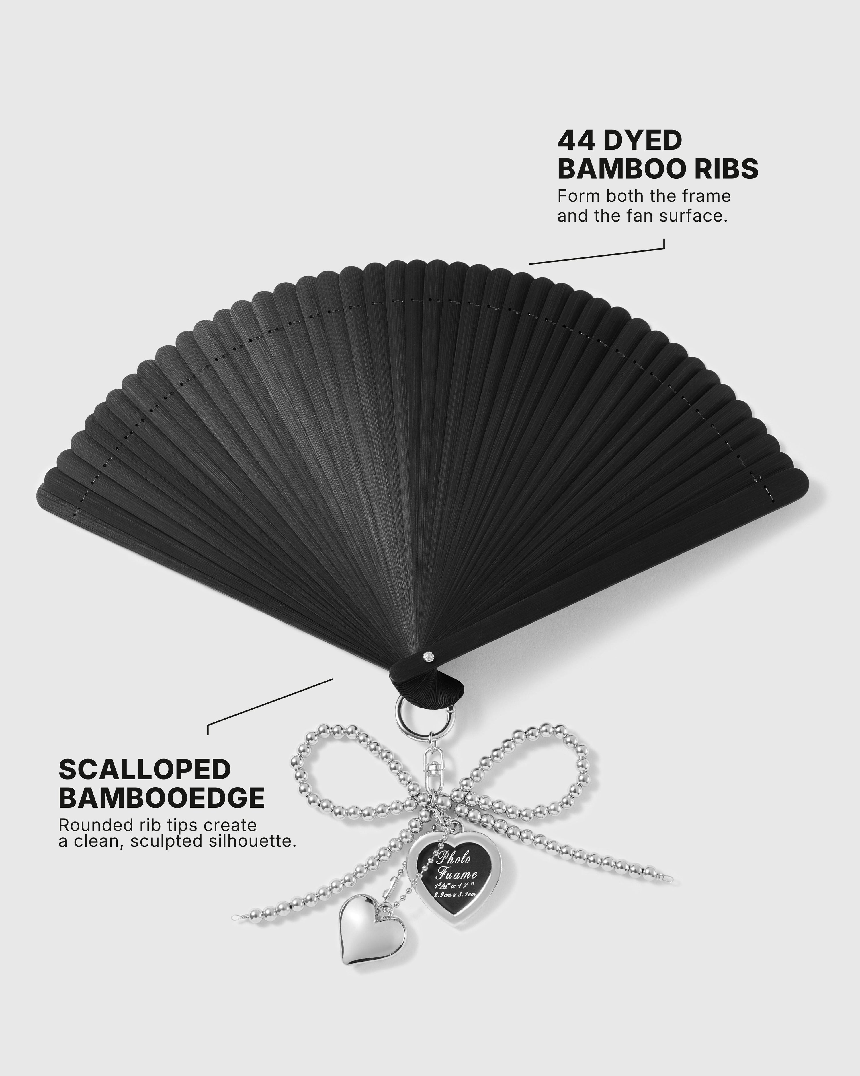 Open black hand fan showing 44 dyed bamboo ribs and scalloped edge