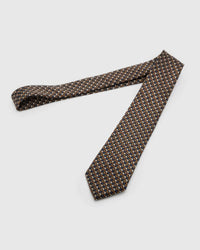 Espresso Chevron Tie laid full length to show espresso, cobalt, ivory and taupe micro chevrons from blade to tail.