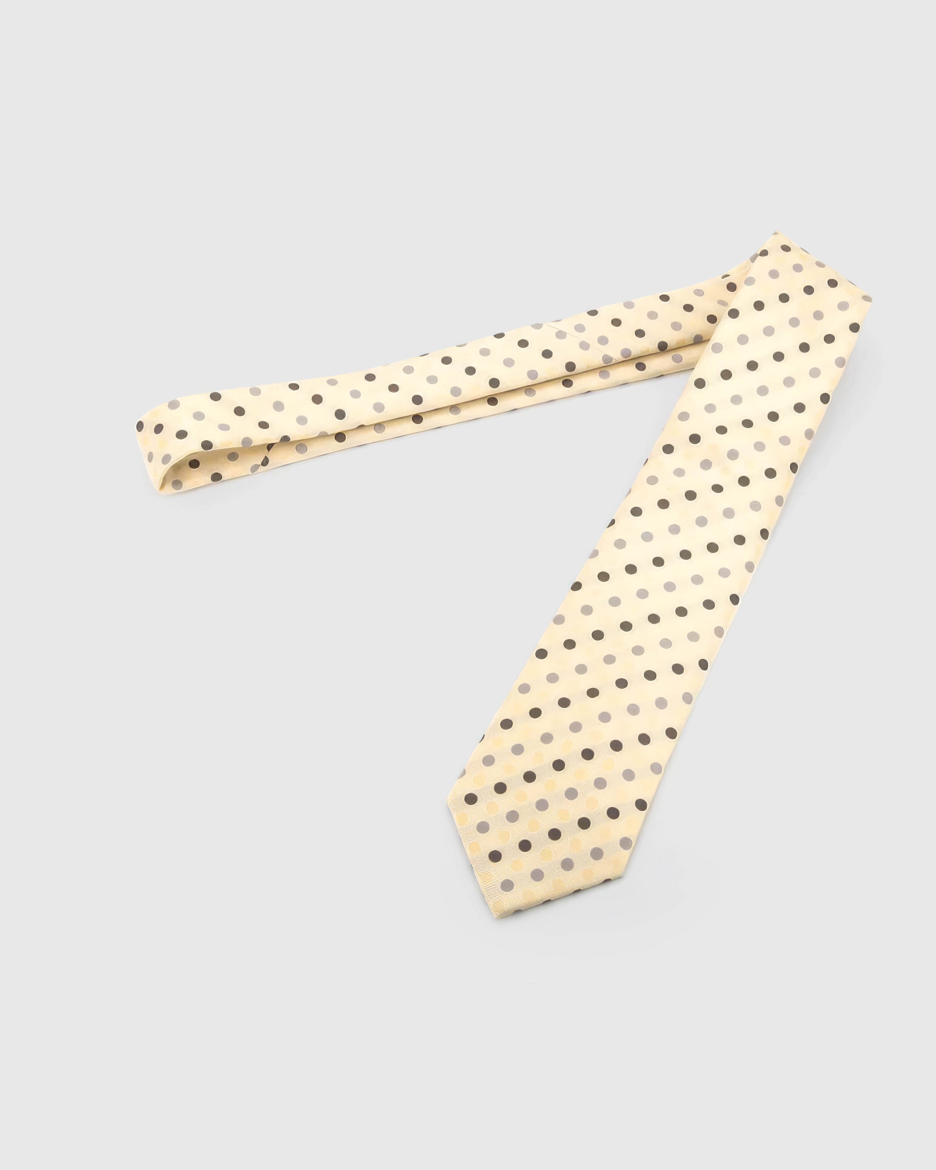 Full-length STICKYZOO Ivory Tricolor Dot Tie laid flat on white, showing the complete espresso, pewter and cream polka dots repeat and 145 × 8 cm proportions