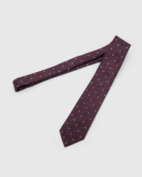 Claret Four-Dot Tie laid full length to show claret crosshatch with white four-dot clusters from blade to tail.
