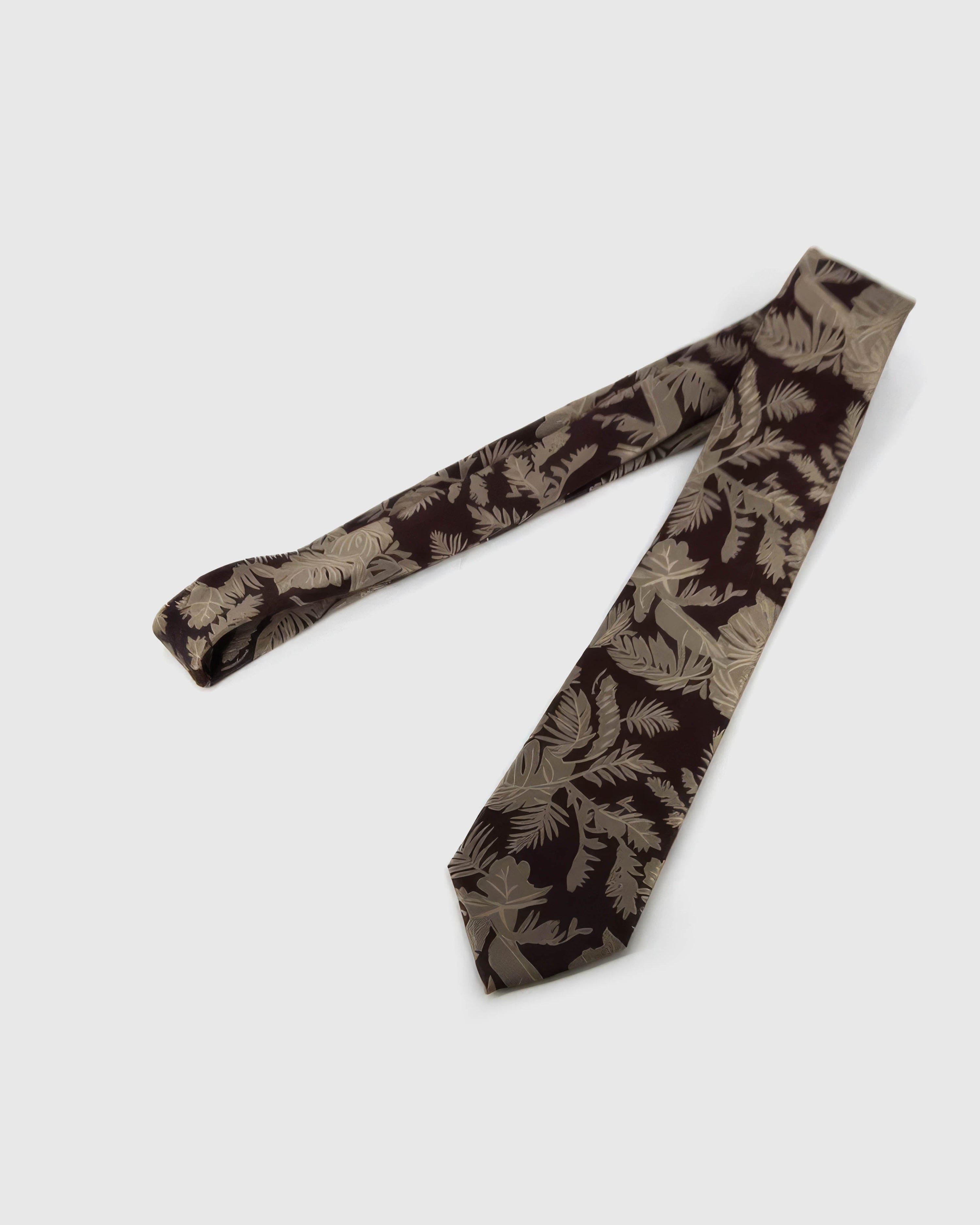 Full-length STICKYZOO Espresso Tropical Leaf Tie showing ivory tropical leaves across a 145 × 8 cm hand-finished mulberry silk tie