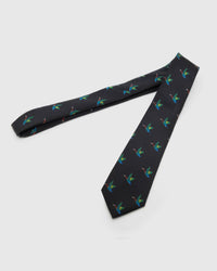 Noir Crane Tie laid full length to show noir ground with colourful flying cranes from blade to tail.