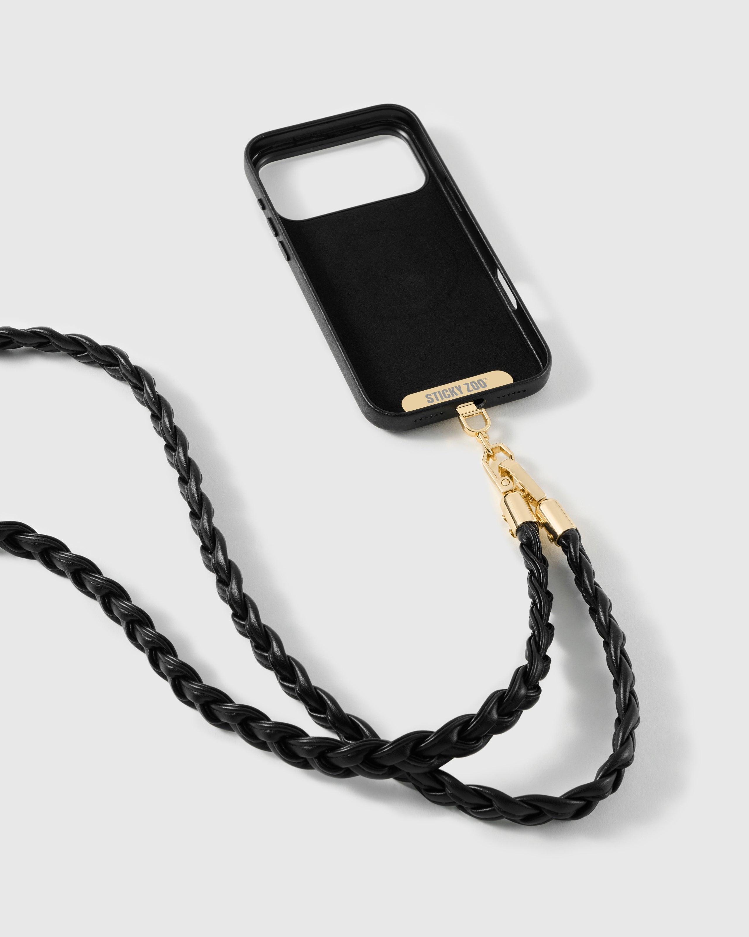 Black braided cross-body phone strap attached to a black phone case for hands-free everyday carry