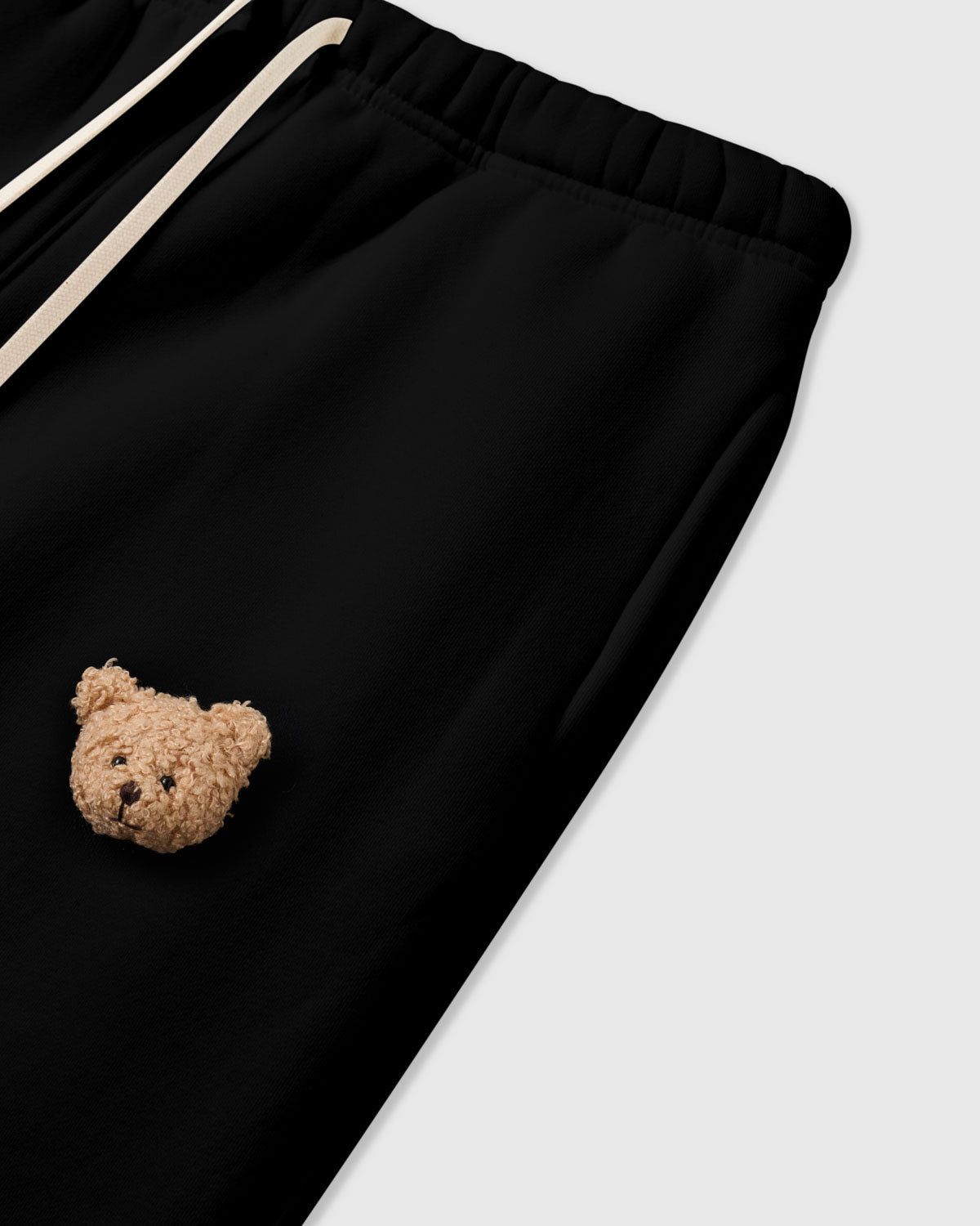 Detail of second bear applique on STICKYZOO black Sticky Bear Sweatpant